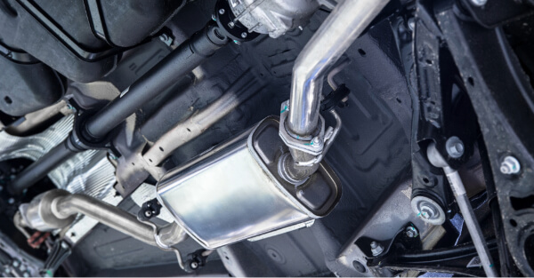 Underside of a car showing the exhaust pipe, muffler and drive shaft